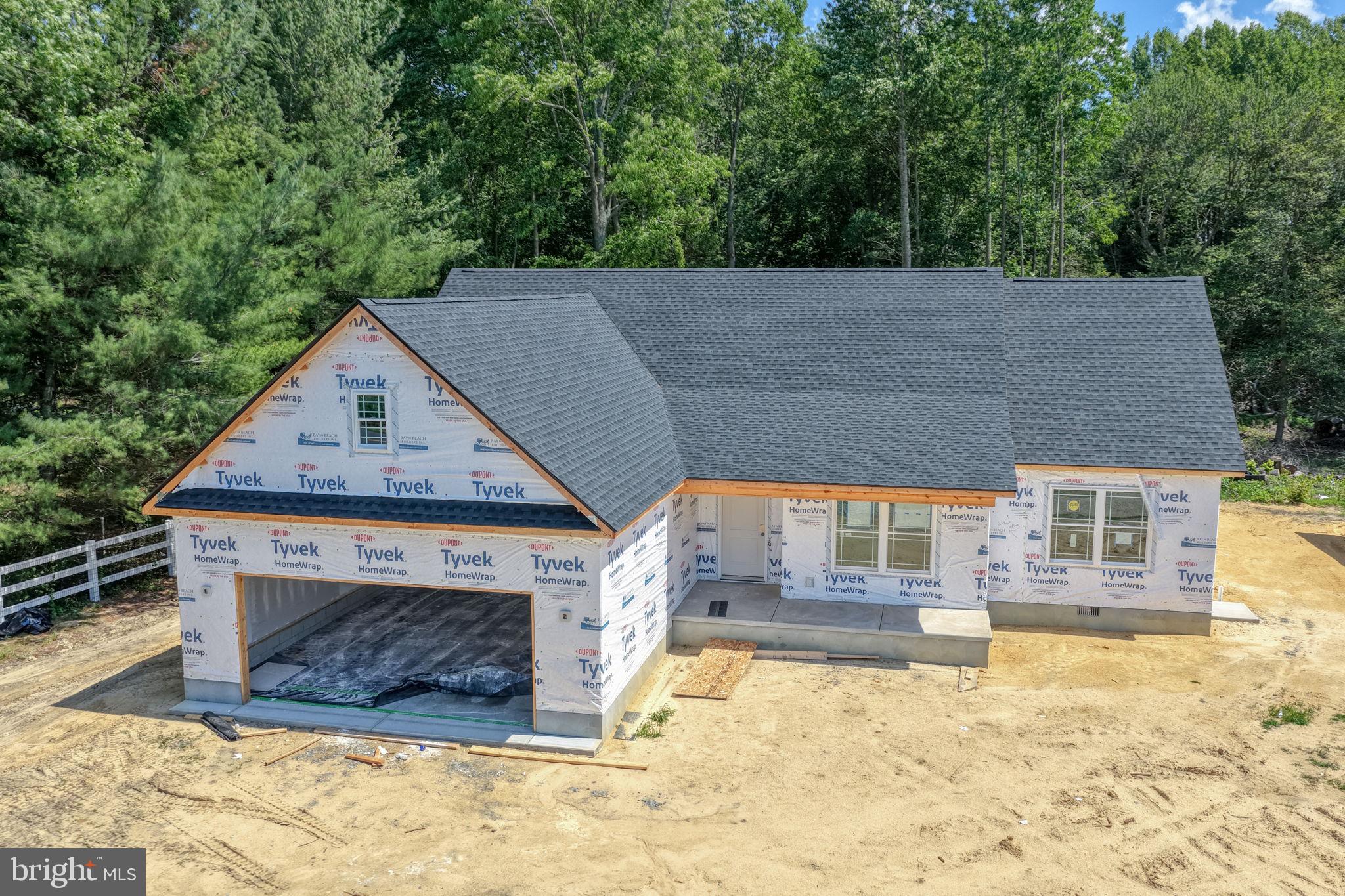 New home under construction, nature's backdrop.