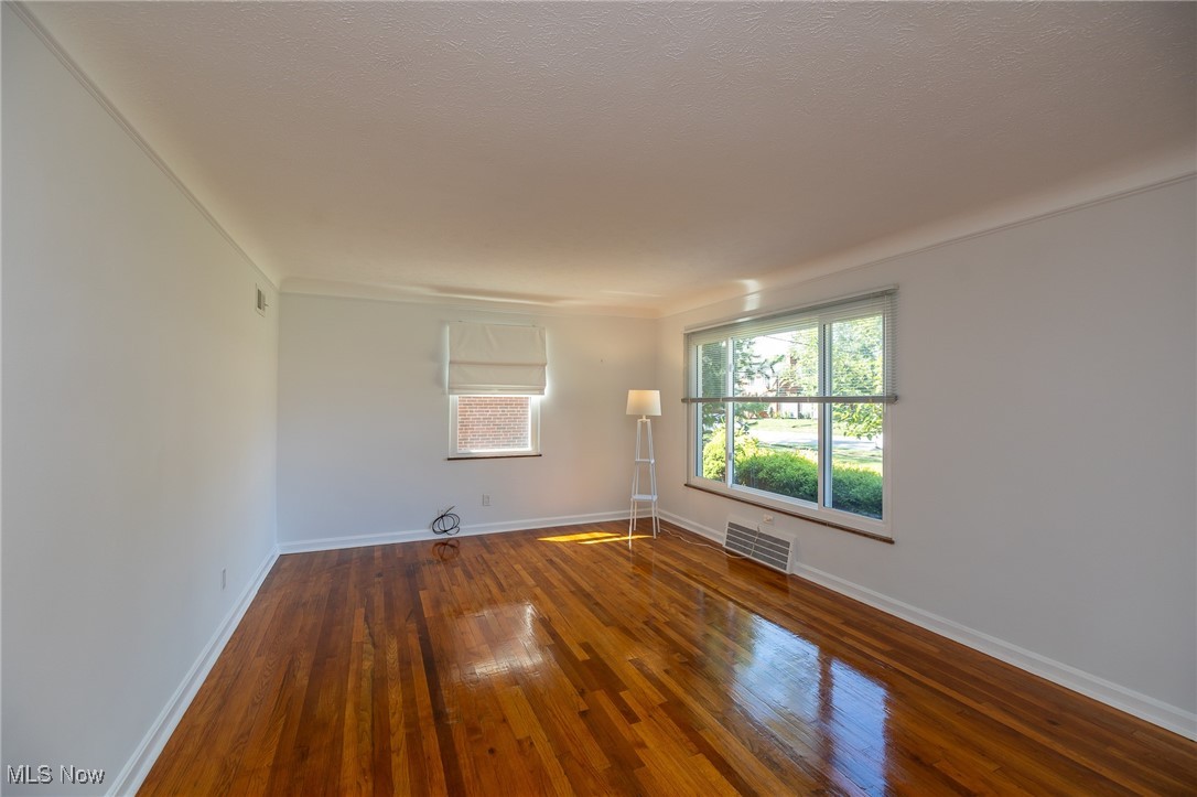 21475 Eaton Road Cleveland, OH 44126 - Photo 19 of 31 Unfurnished room with a textured ceiling and dark hardwood / wood-style flooring