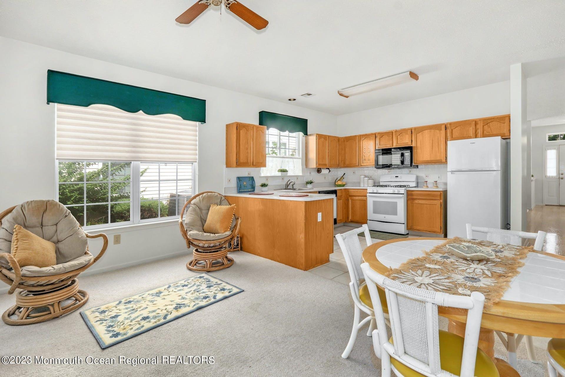 54 Sandpiper Road Barnegat, NJ 08005 - Photo 13 of 27 a kitchen with a stove a refrigerator and a dining table