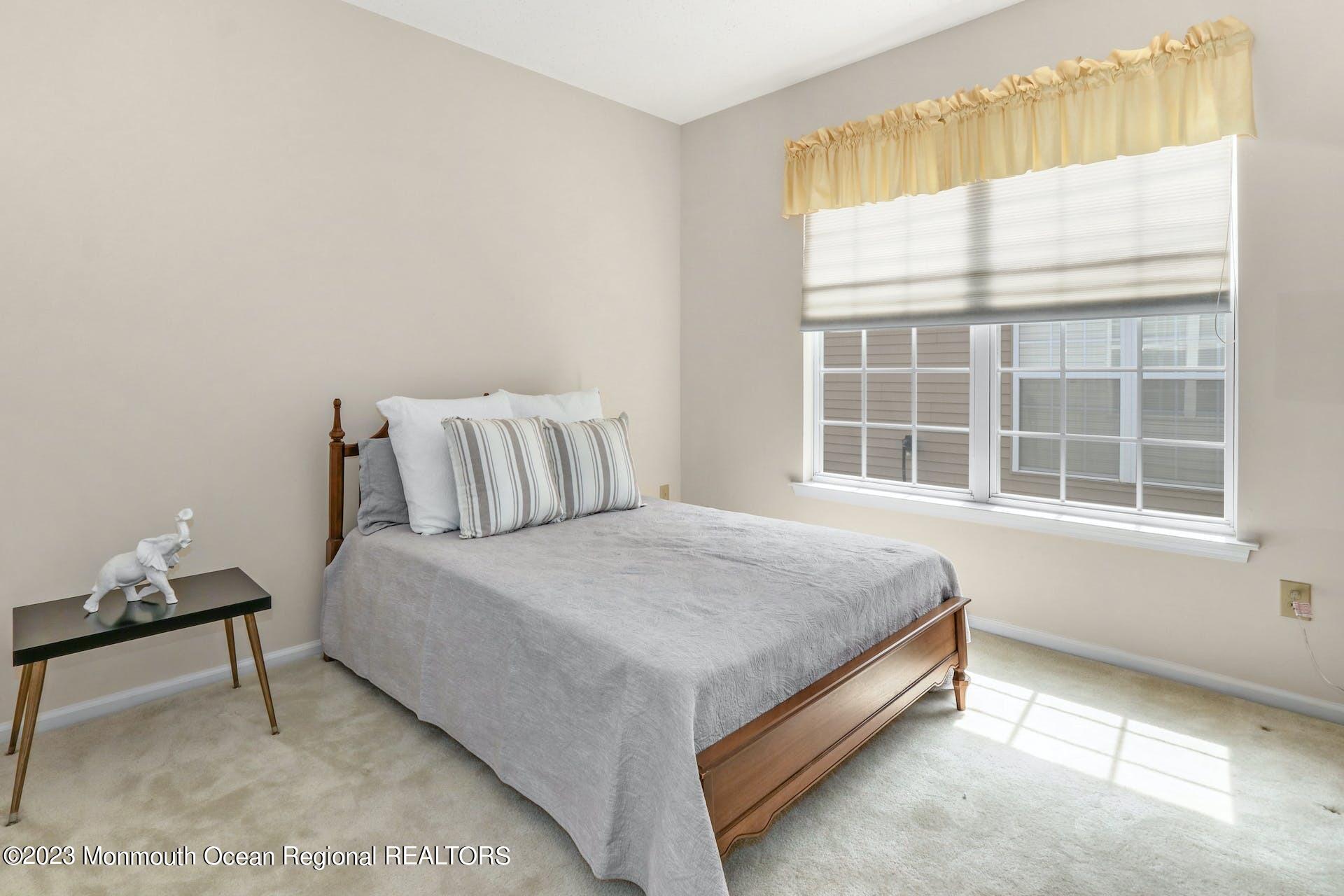 54 Sandpiper Road Barnegat, NJ 08005 - Photo 22 of 27 a bed sitting in a bedroom next to a window