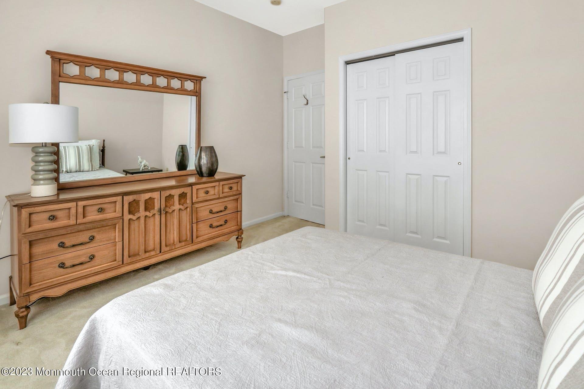 54 Sandpiper Road Barnegat, NJ 08005 - Photo 23 of 27 a spacious bedroom with a bed and a dresser in it