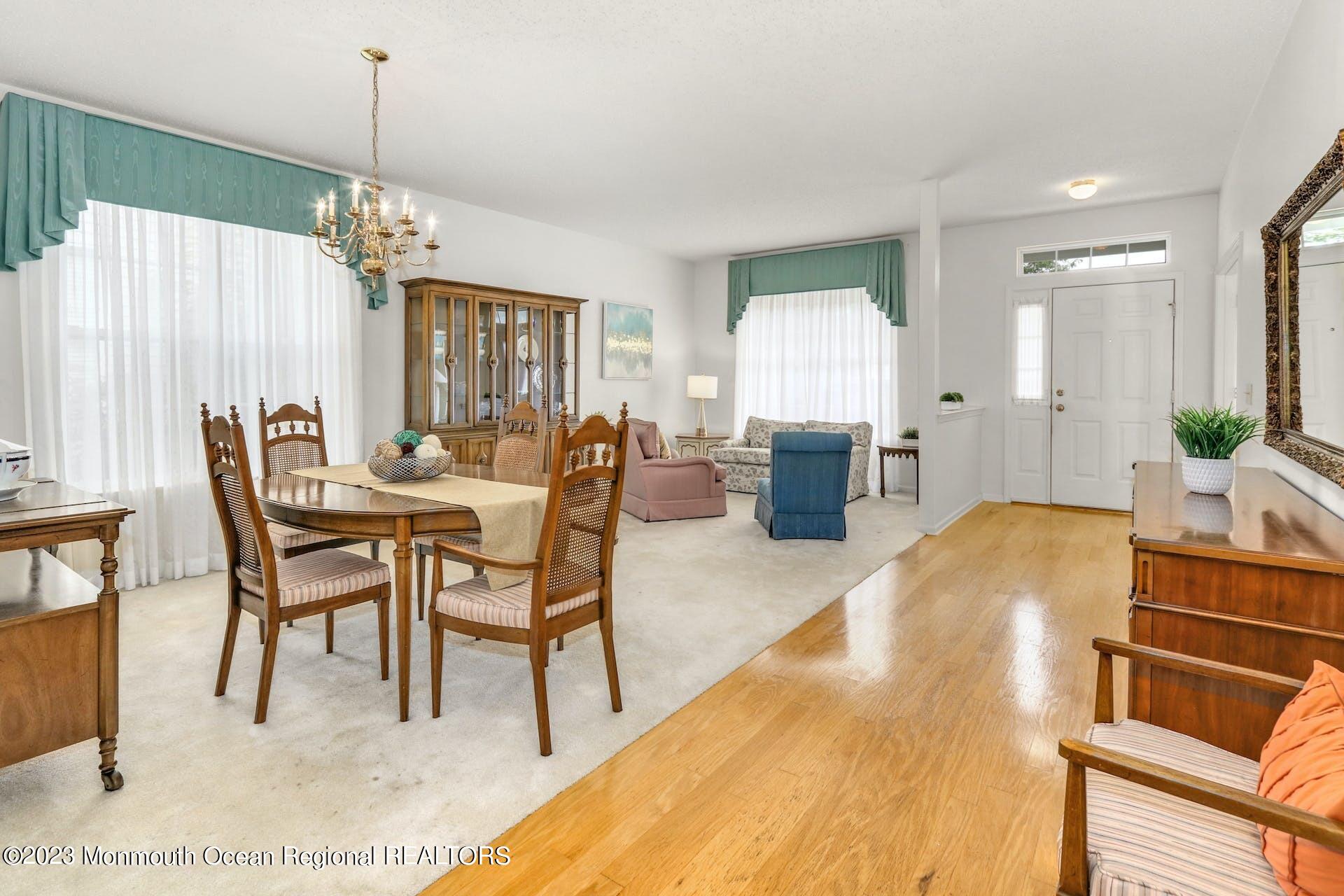 54 Sandpiper Road Barnegat, NJ 08005 - Photo 5 of 27 a living room with dining table furniture and a chandelier