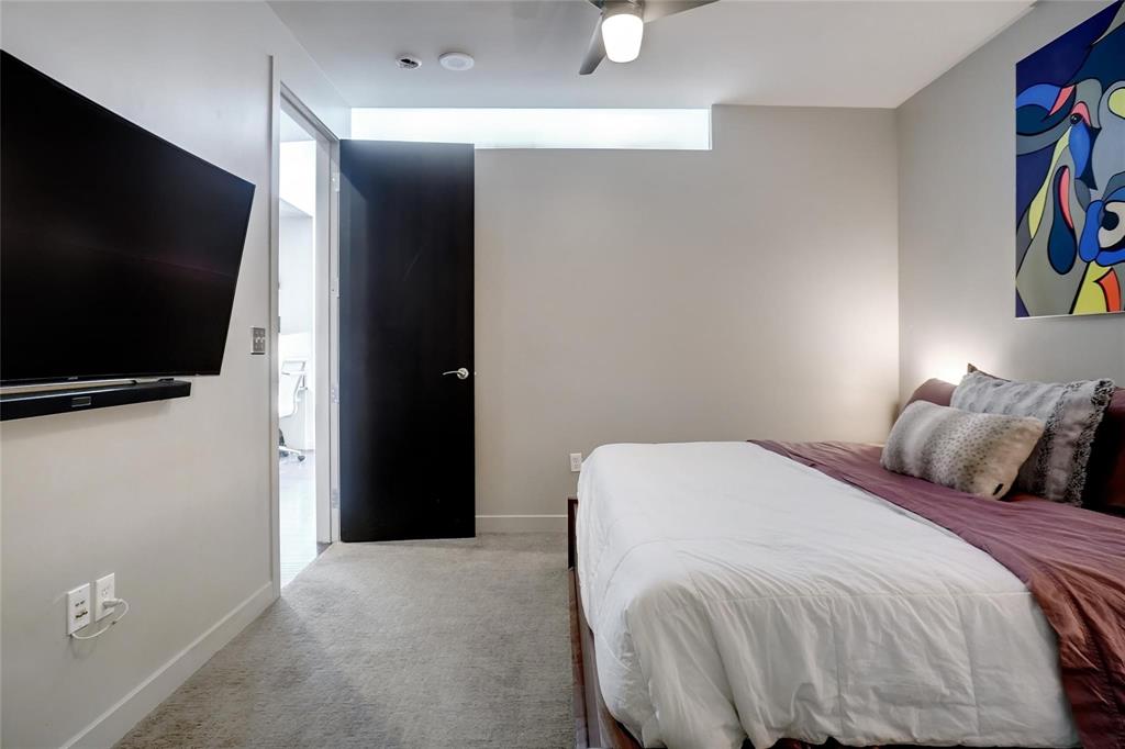 2600 West 7th Street, Unit 1807 Fort Worth, TX 76107 - Photo 12 of 27 a bedroom with a bed and a flat screen tv