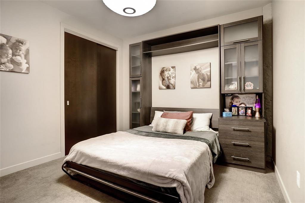 2600 West 7th Street, Unit 1807 Fort Worth, TX 76107 - Photo 17 of 27 a bedroom with a bed and a painting on the wall