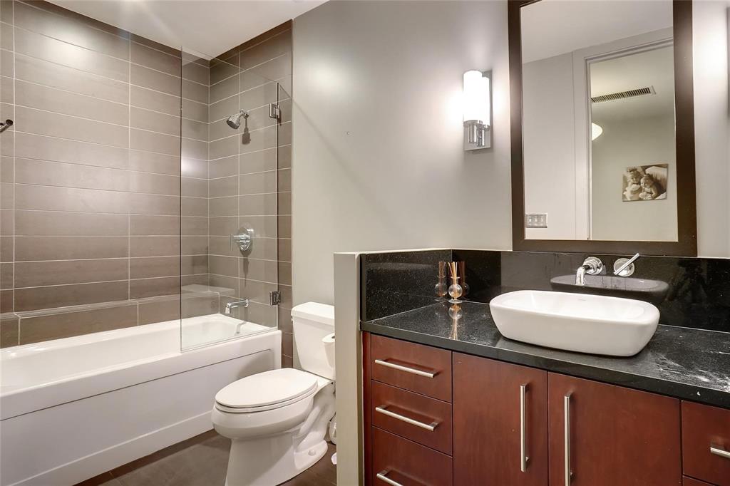 2600 West 7th Street, Unit 1807 Fort Worth, TX 76107 - Photo 18 of 27 a bathroom with a sink toilet vanity and shower