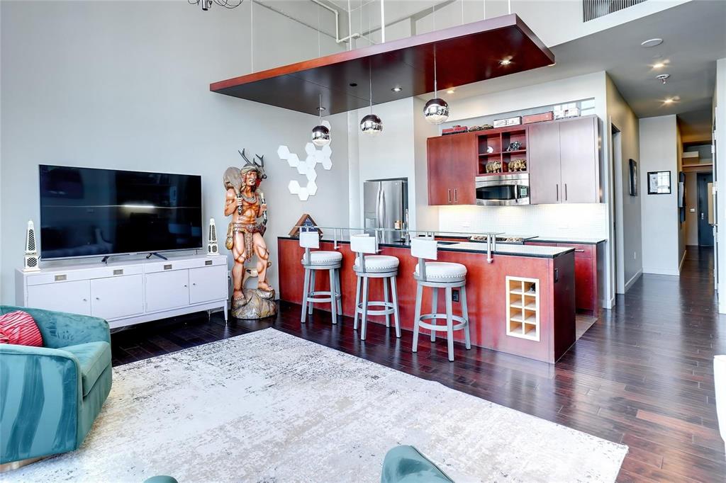 2600 West 7th Street, Unit 1807 Fort Worth, TX 76107 - Photo 4 of 27 a living room with stainless steel appliances kitchen island furniture and a flat screen tv