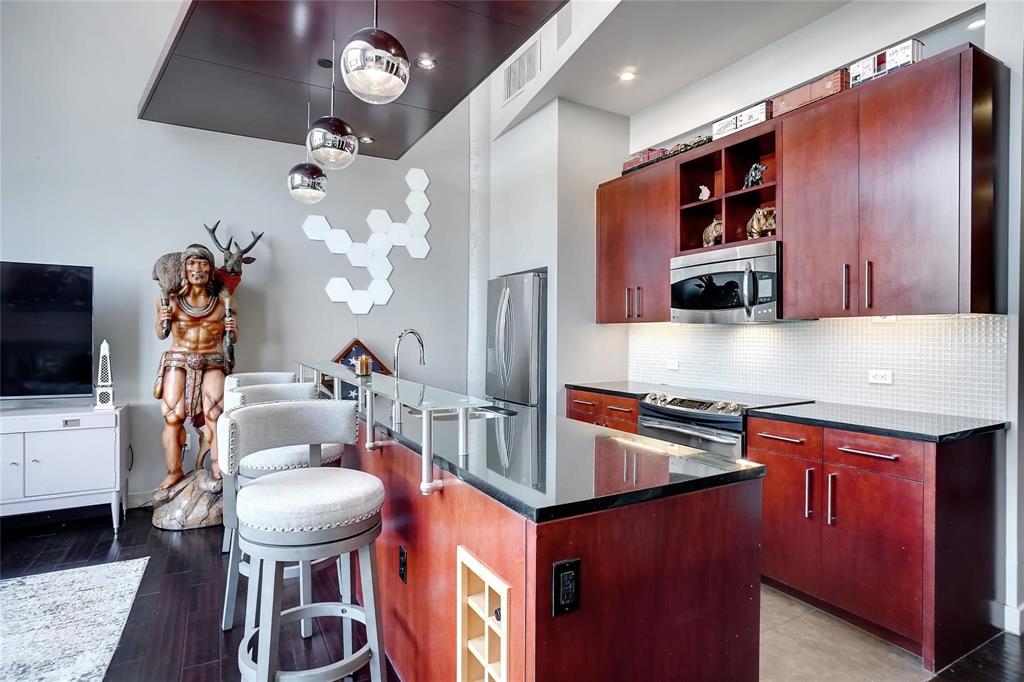 2600 West 7th Street, Unit 1807 Fort Worth, TX 76107 - Photo 8 of 27 a kitchen with stainless steel appliances granite countertop a sink a stove and a refrigerator