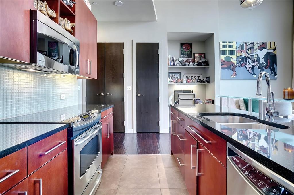 2600 West 7th Street, Unit 1807 Fort Worth, TX 76107 - Photo 10 of 27 a kitchen with stainless steel appliances granite countertop a refrigerator and a stove