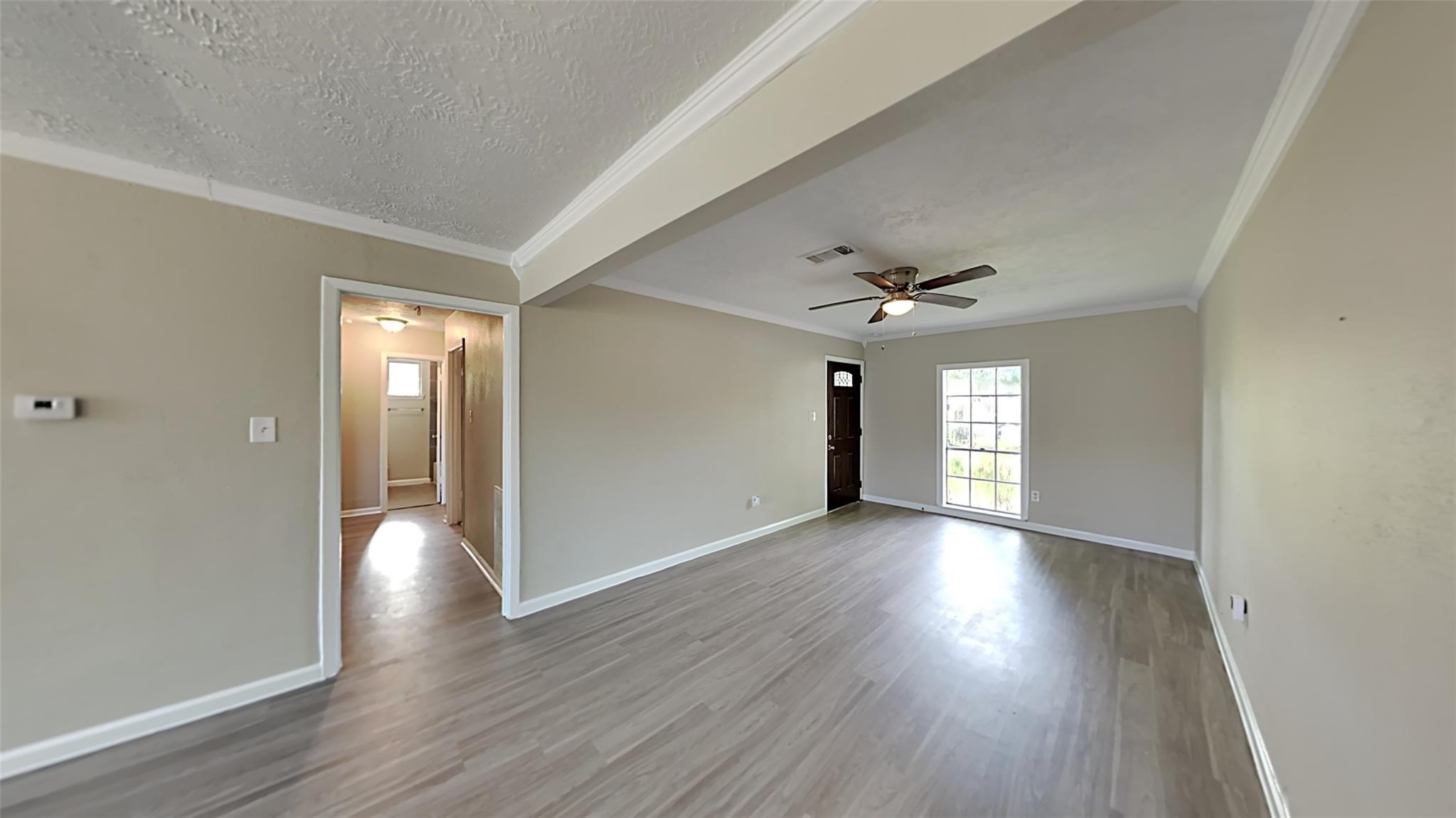 6706 Castleview Lane Houston, TX 77489 - Photo 2 of 17 wooden floor in an empty room with a window