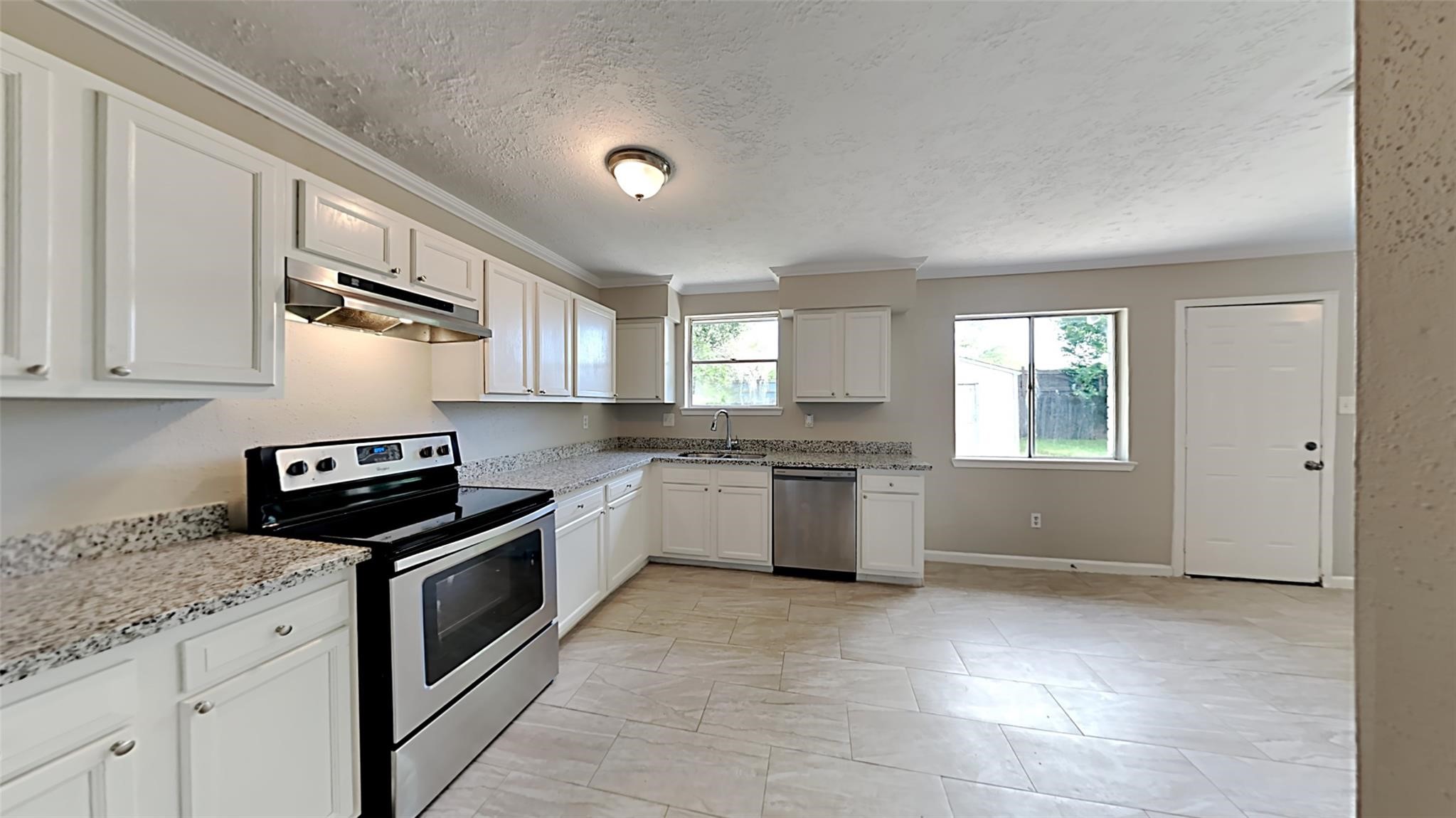 6706 Castleview Lane Houston, TX 77489 - Photo 4 of 17 a kitchen with granite countertop a stove sink and cabinets