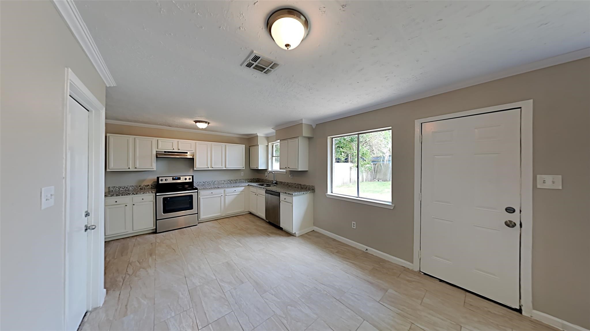 6706 Castleview Lane Houston, TX 77489 - Photo 5 of 17 a kitchen with stainless steel appliances granite countertop a stove a sink and a refrigerator