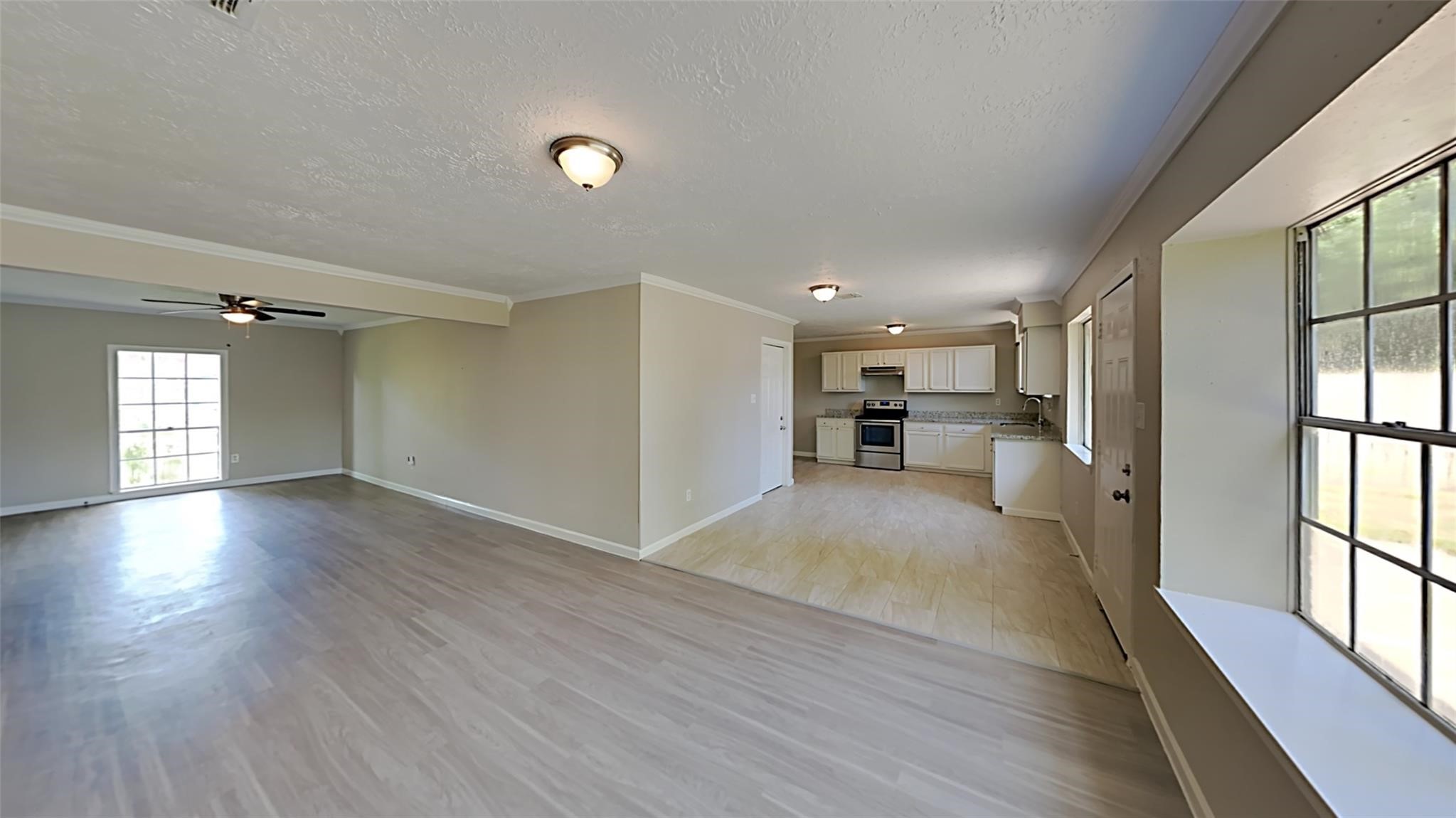 6706 Castleview Lane Houston, TX 77489 - Photo 7 of 17 a view of empty room with wooden floor and window