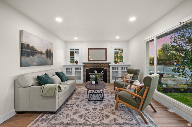 189 West Center Street Midvale, UT 84047 - Photo 10 of 64 Living area featuring wood-finish flooring, recessed lighting, and a brick fireplace