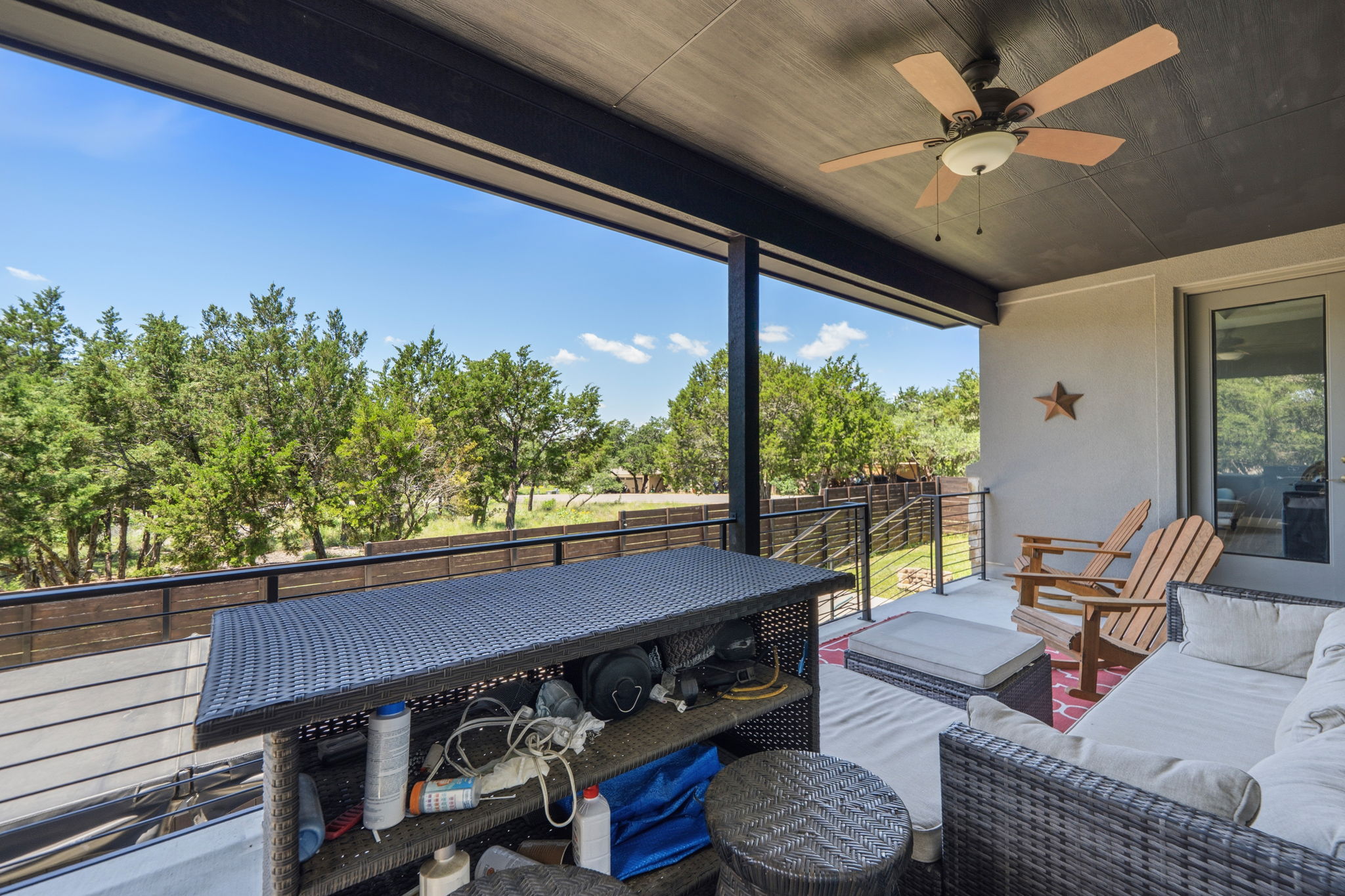 18605 Masters Cove Point Venture, TX 78645 - Photo 29 of 40 Expansive covered balcony featuring a ceiling fan, a smooth concrete surface, and dark metal railings