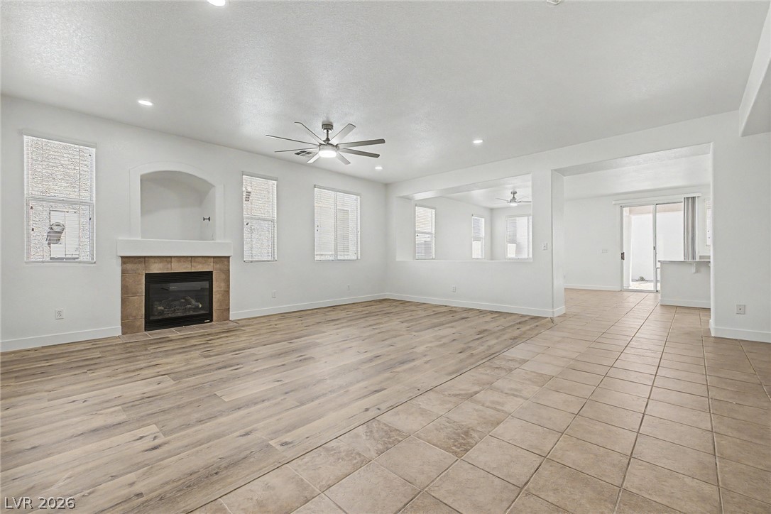 835 Entrada Ridge Avenue Henderson, NV 89012 - Photo 5 of 34 A well-lit gathering space with diverse flooring and a charming fireplace.