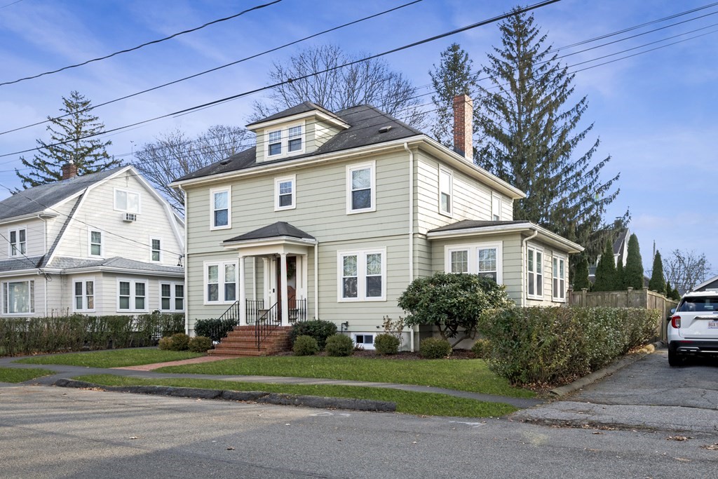 a front view of a house with a garden