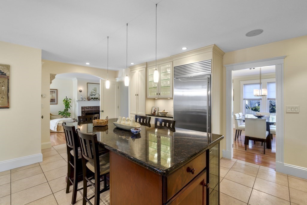 14 Homestead Road Marblehead, MA 01945 - Photo 25 of 41 a kitchen with granite countertop a table chairs stove and refrigerator