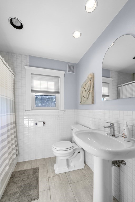 14 Homestead Road Marblehead, MA 01945 - Photo 39 of 41 a bathroom with a granite countertop sink a mirror and a toilet