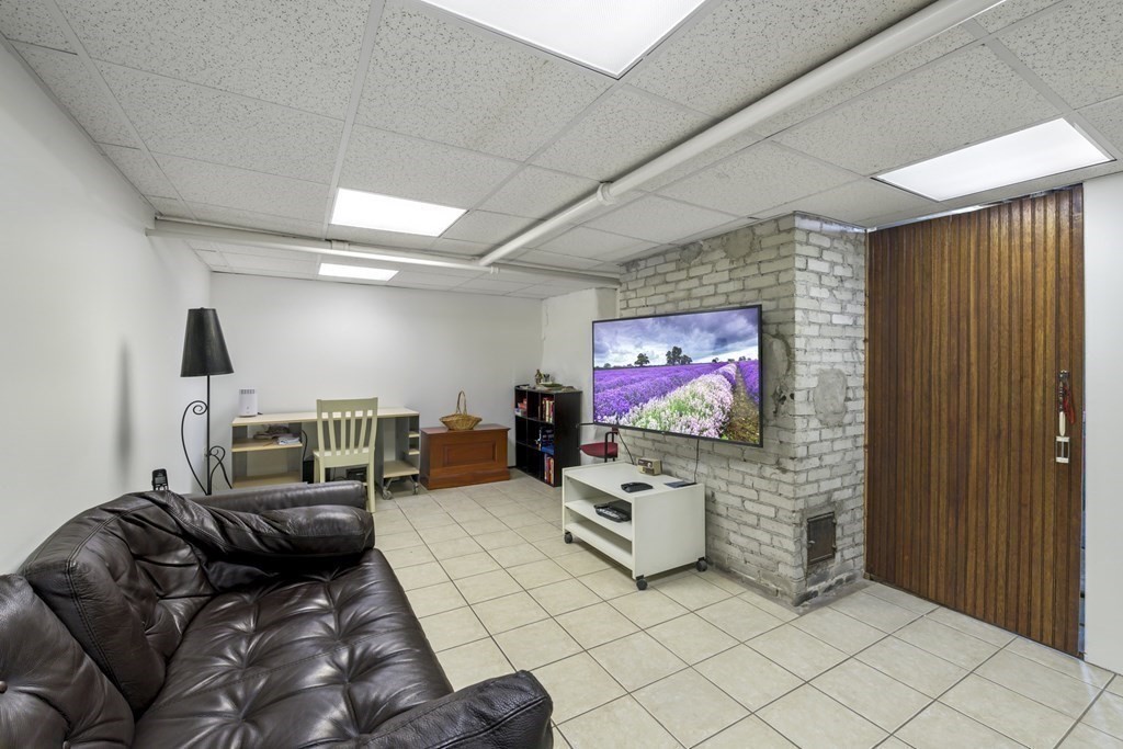 14 Homestead Road Marblehead, MA 01945 - Photo 40 of 41 a living room with furniture and a flat screen tv