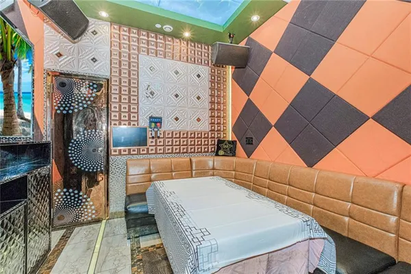 a room with water heater and a wooden floor