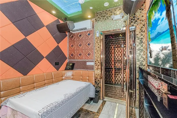 a bathroom with a sink a mirror and painting on the wall