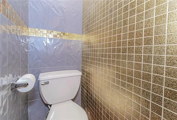 a bed sitting in a room next to a lamp