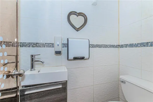 a view of a kitchen with stainless steel appliances granite countertop a stove and a sink