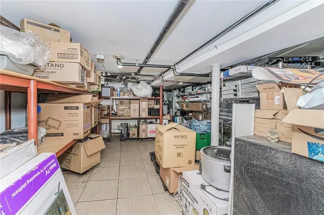 a view of a storage room with water heater and racks