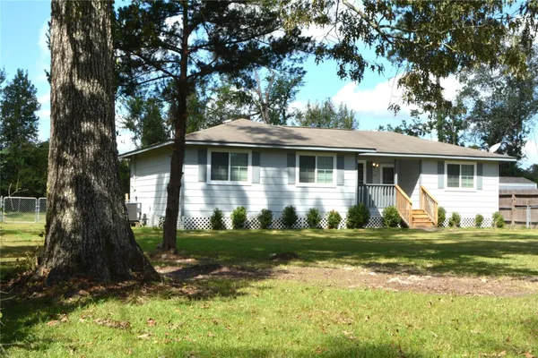 a front view of a house with a yard porch and outdoor seating