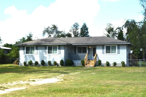a front view of a house with a yard table and chairs