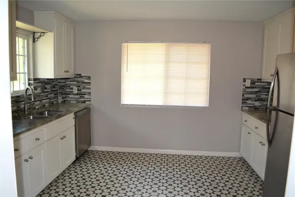 a bathroom with a sink a vanity and a window