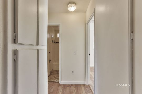 712 South Alvord Street Ridgecrest, CA 93555 - Photo 22 of 33 an empty room with wooden floor and a bathroom