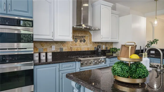 a kitchen with a stove a microwave and cabinets