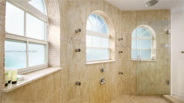 a bedroom with a bed and a large window