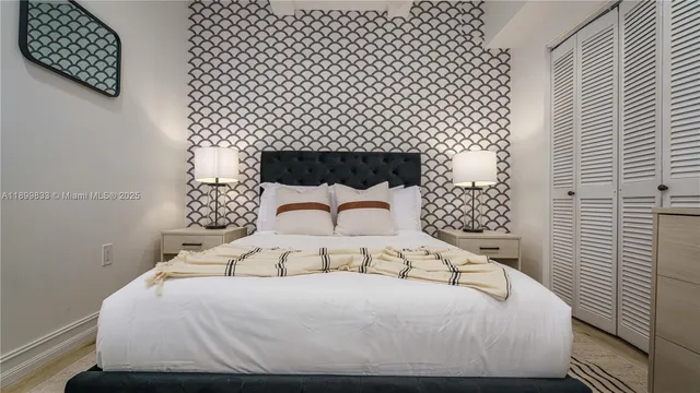 a bedroom with a bed and a wall painting