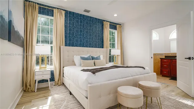 a bed sitting in a bedroom next to a window