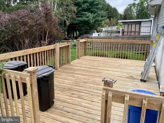 a view of a deck with wooden floor and fence