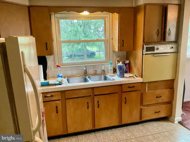 a kitchen with sink cabinets and refrigerator