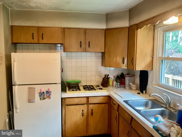 a kitchen with a refrigerator and a sink