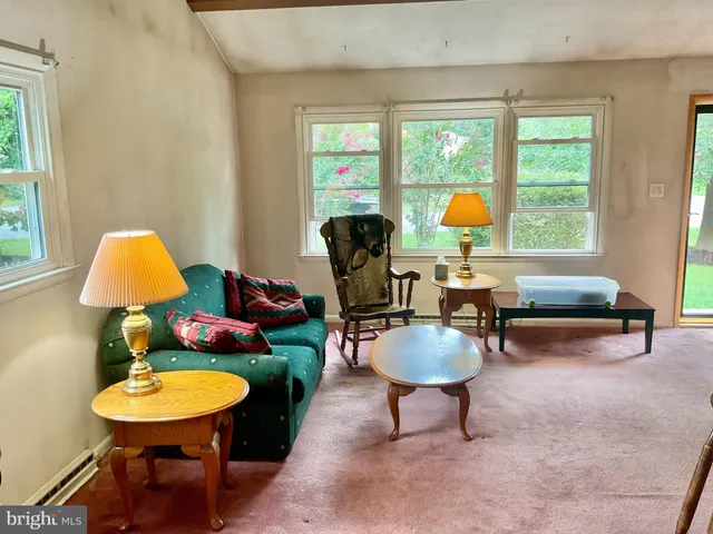 a living room with furniture a fireplace and a table
