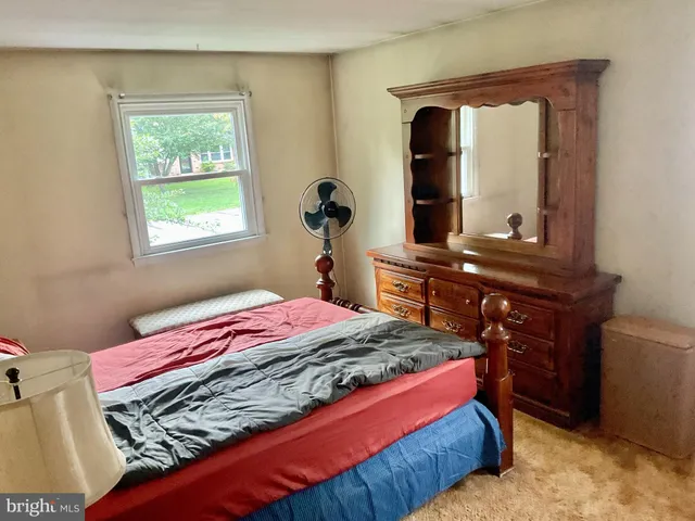 a bedroom with a bed and a dresser