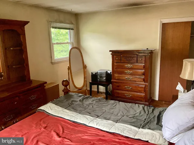 a bed room with a bed and a dresser