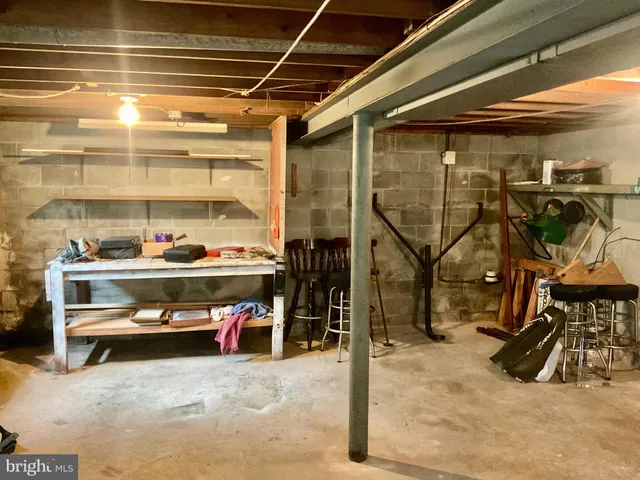 a living room with furniture and a dining table with wooden floor