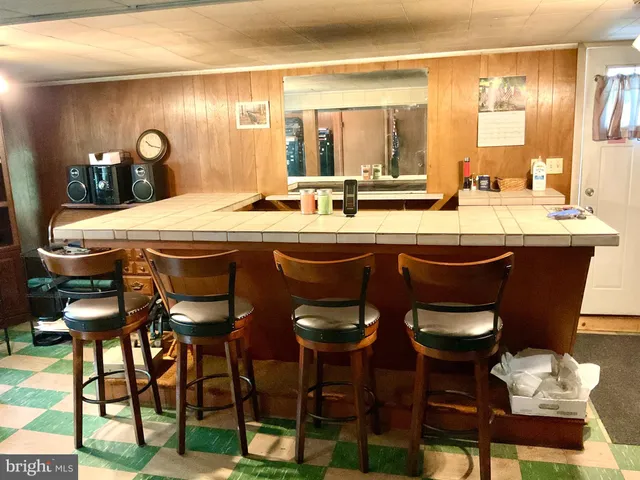 a dining room with a sink and chairs
