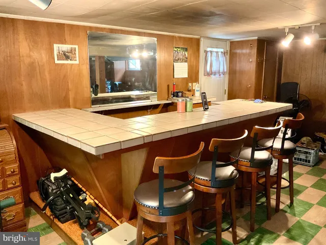 a large kitchen with a table and chairs