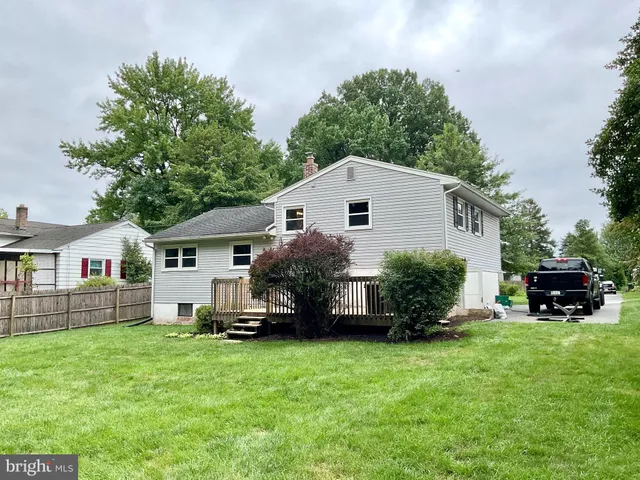 a front view of a house with a garden and yard
