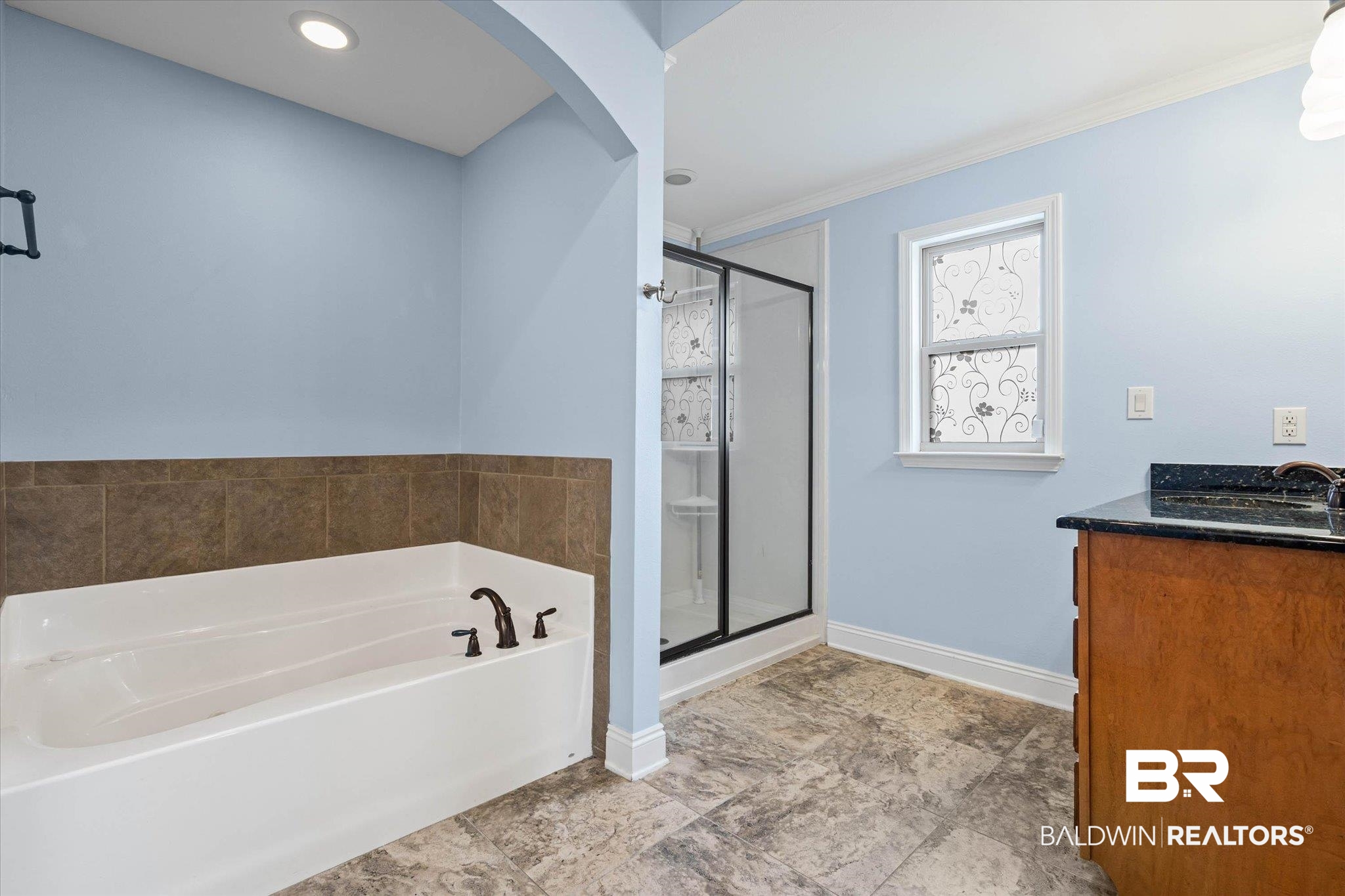 704 Edinburgh Avenue Foley, AL 36535 - Photo 21 of 32 Bathroom with vanity, a stall shower, a garden tub, and ornamental molding