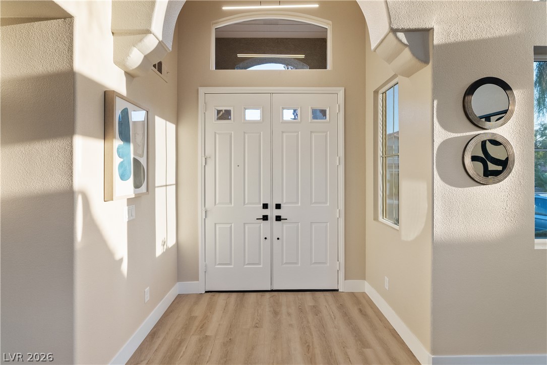 1662 Ravanusa Drive Henderson, NV 89052 - Photo 57 of 74 Architectural arches frame the double front doors, offering a grand welcome to this bright entry foyer.