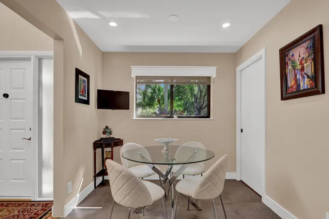 a view of a dining room with furniture and window