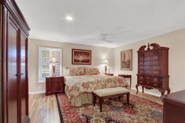 a bedroom with a bed and a dresser with mirror